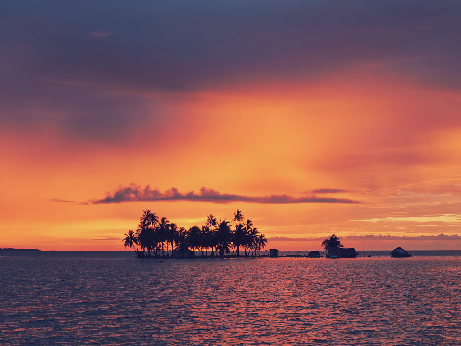 Dramatic sunset over the San Blas Islands during Panama’s rainy season, showing calm waters and ideal sailing conditions