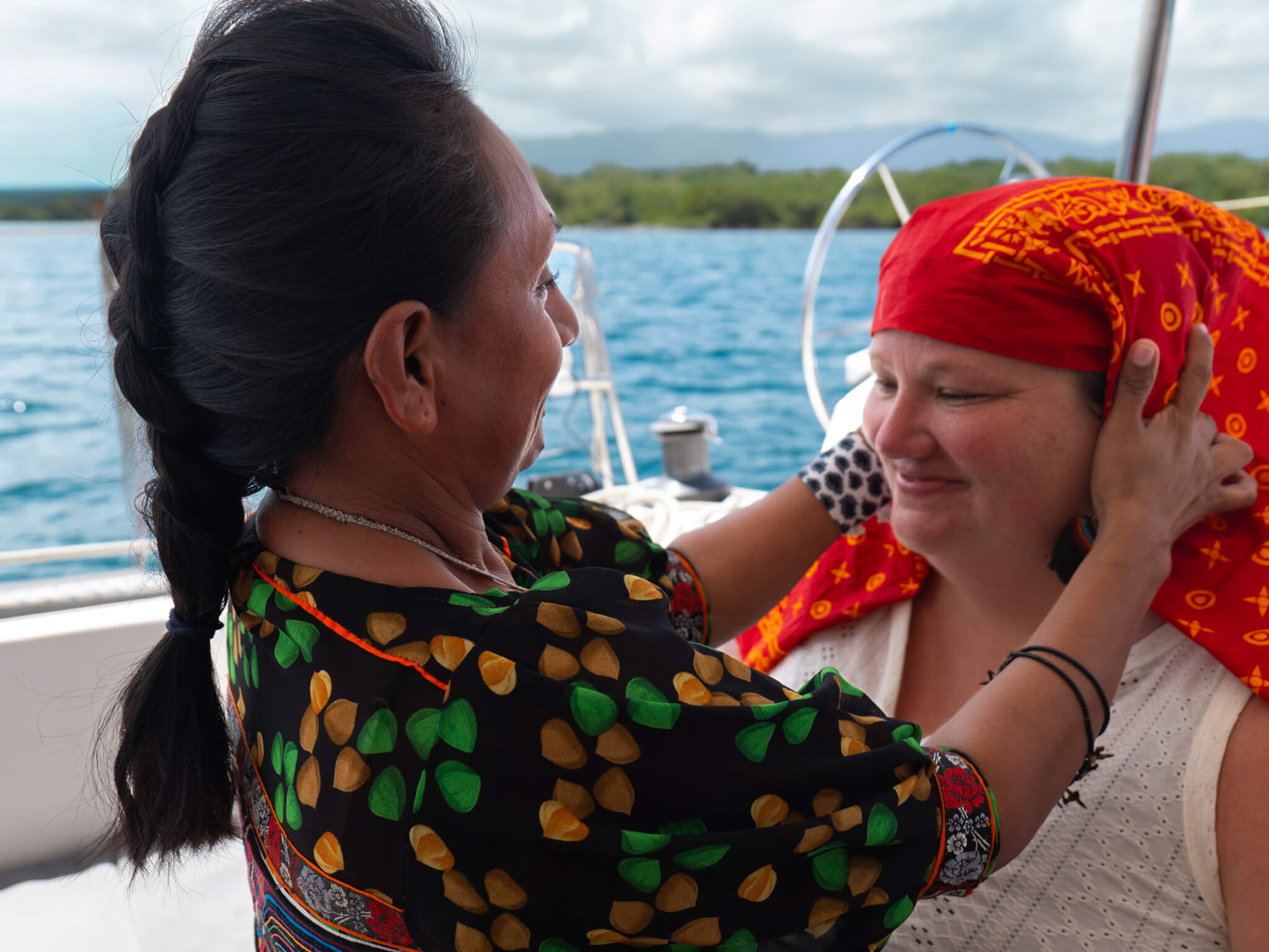 Travelers looking at traditional molas made by the Guna community in San Blas