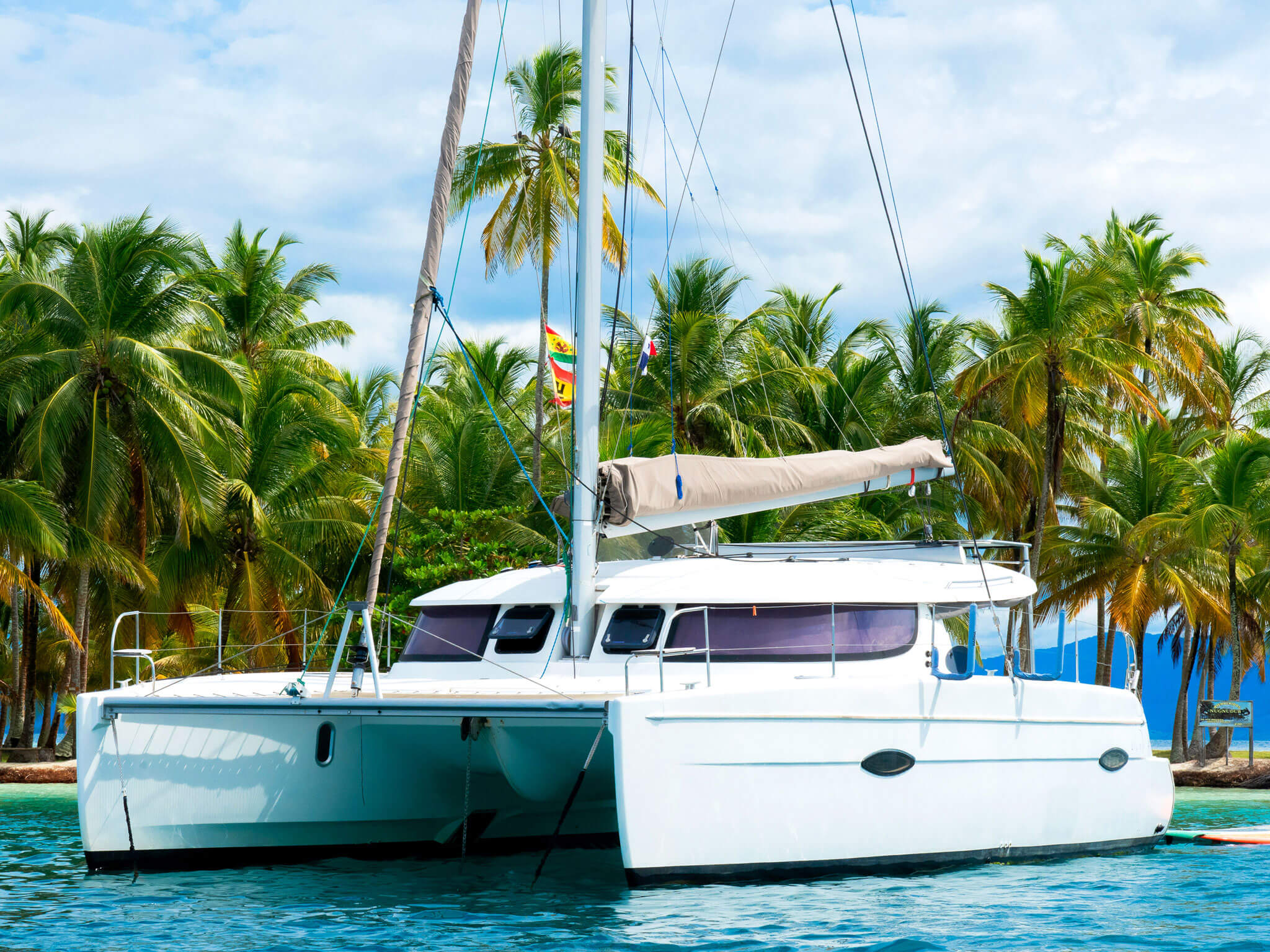 Front and side view of Catamaran Atila anchored in the turquoise waters of Guna Yala.