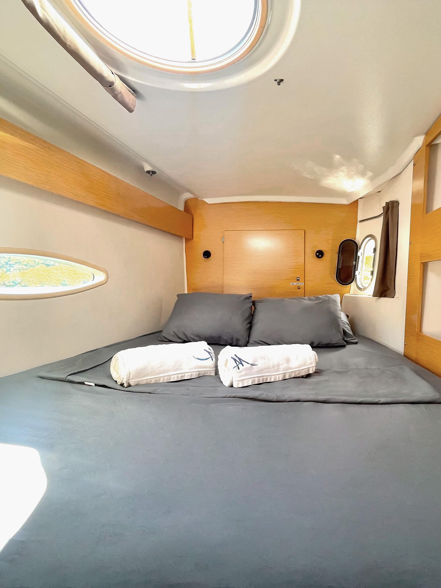 Bow port cabin on Catamaran Atila with comfortable bedding and natural light.