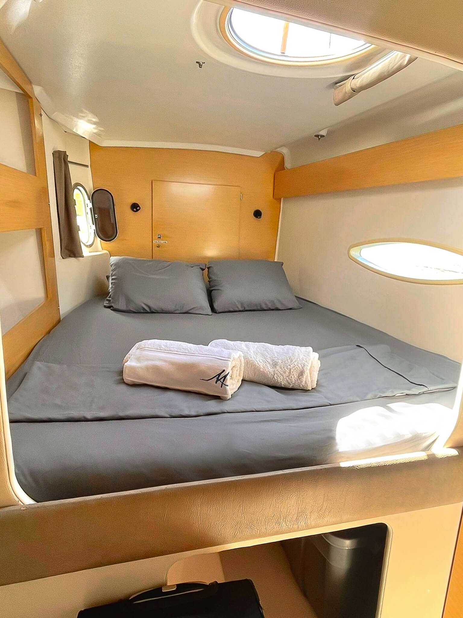 Starboard stern cabin on Catamaran Atila with comfortable bedding and natural light.