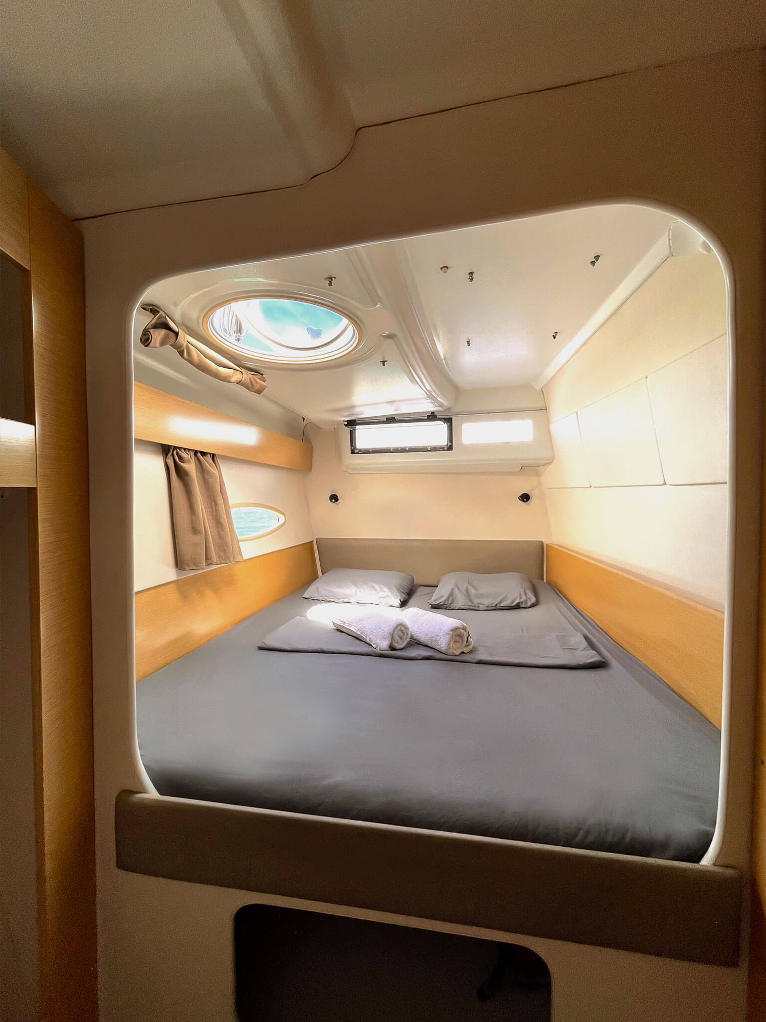 Starboard cabin on Catamaran Atila with comfortable bedding and natural light.
