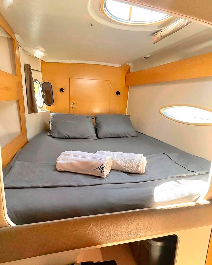Starboard stern cabin on Catamaran Atila with comfortable bedding and natural light.