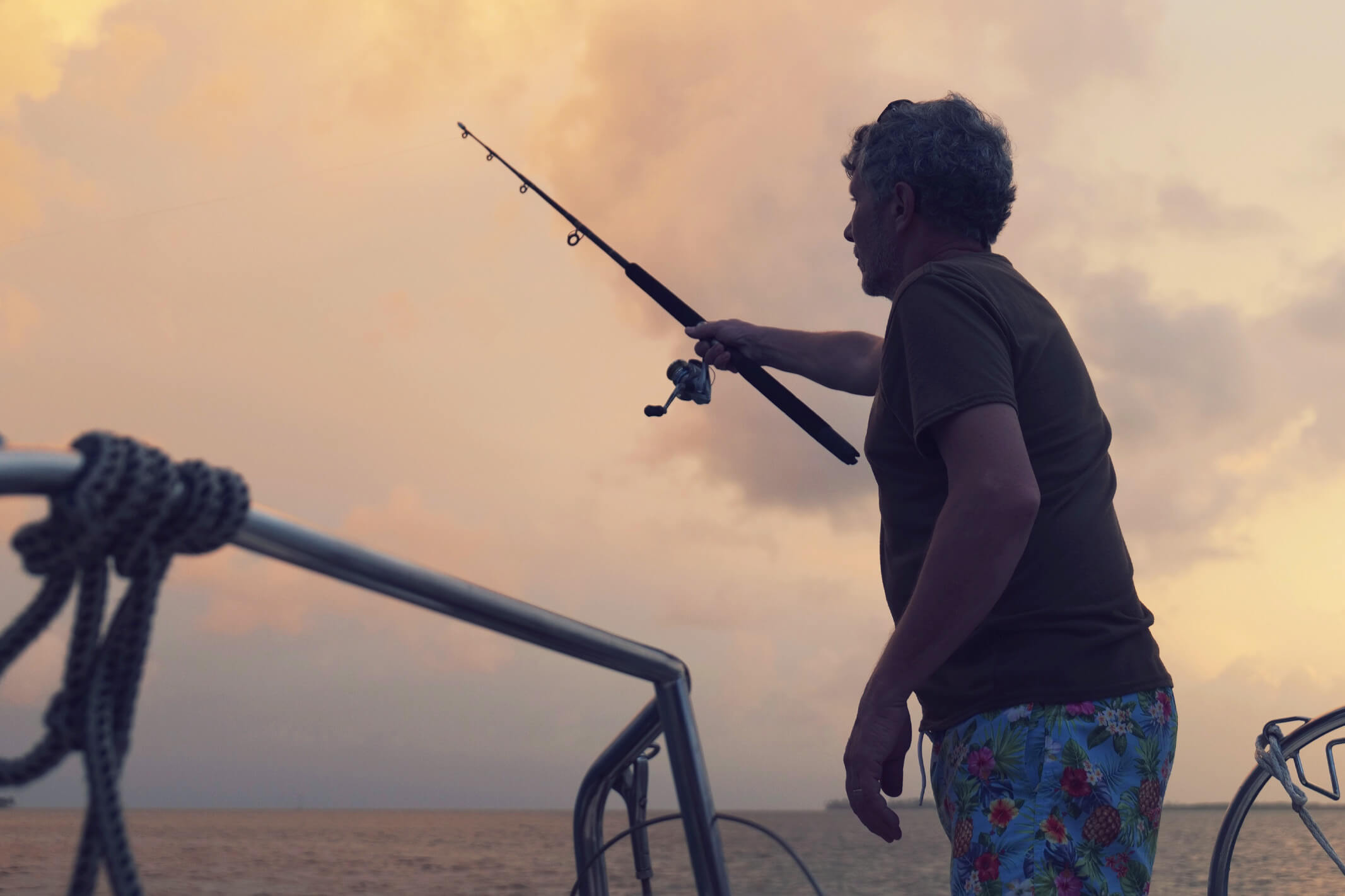 Passenger fishing from the stern of the Lipari 41 catamaran