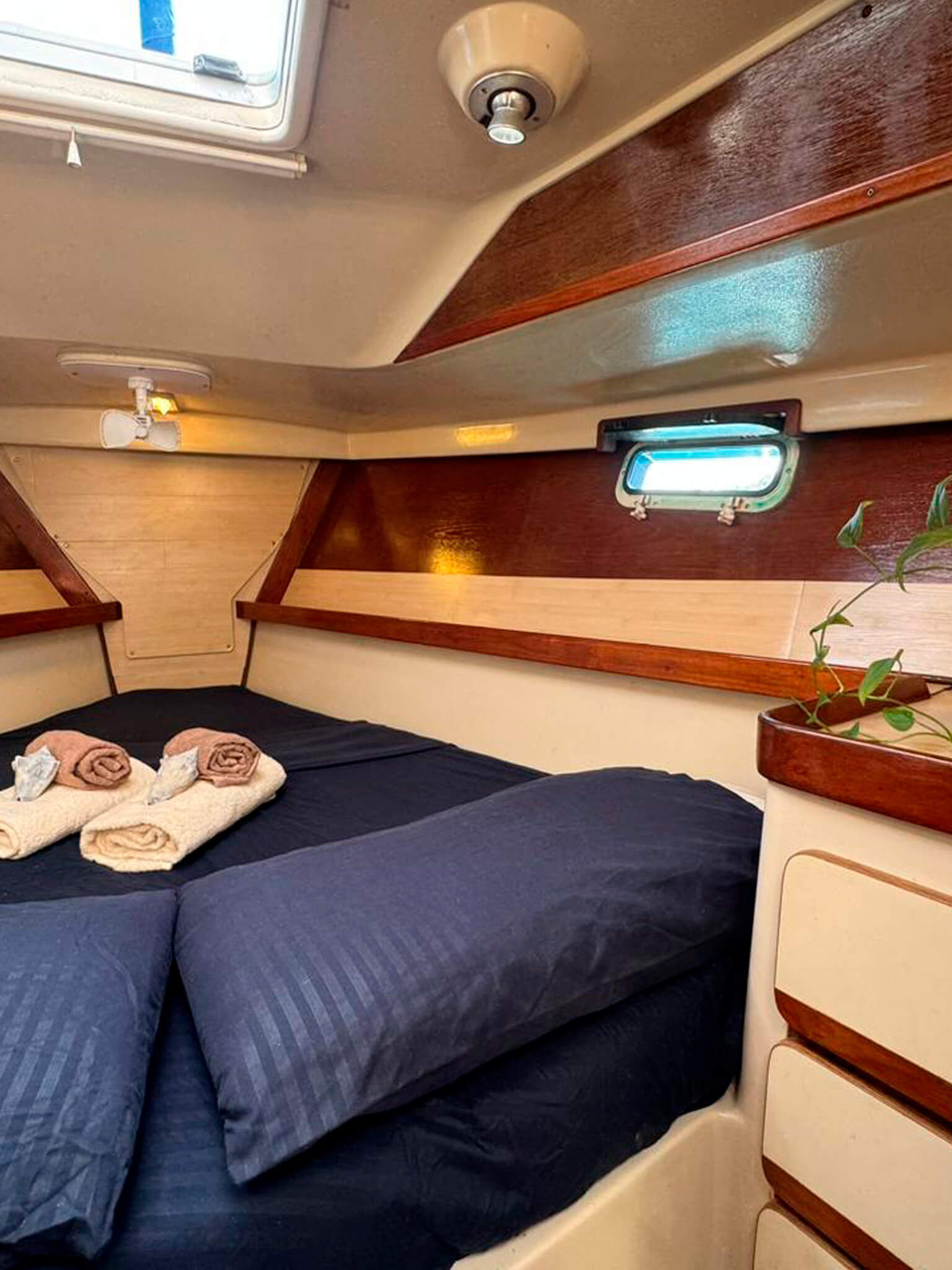Starboard cabin on Catamaran Atila with comfortable bedding and natural light.