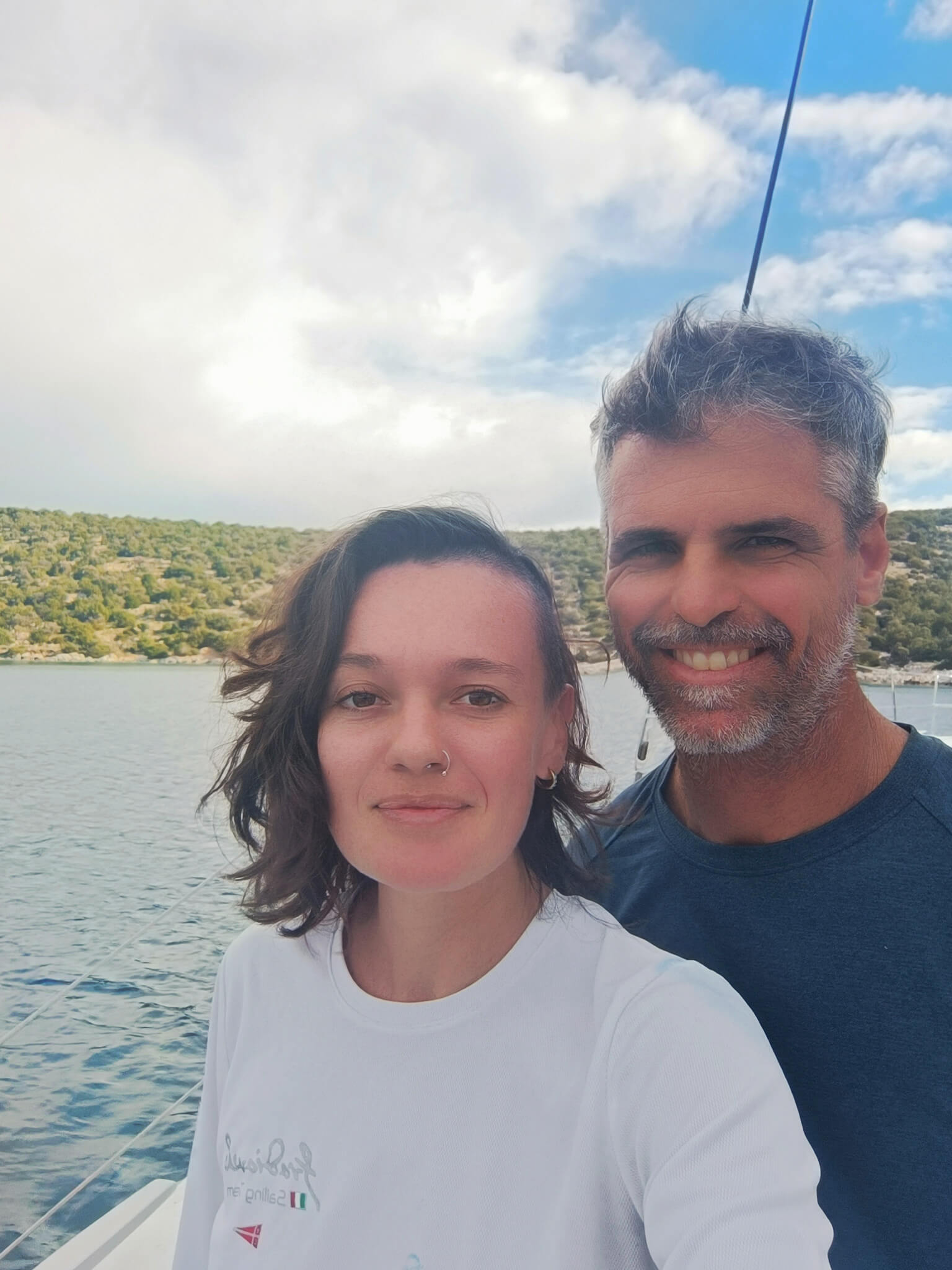 Front and side view of Catamaran Atila anchored in the turquoise waters of Guna Yala.